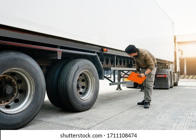  Asian truck driver holding clipboard inspecting around truck, vehicle maintenance safety checklist a truck, road freight industry logistics.