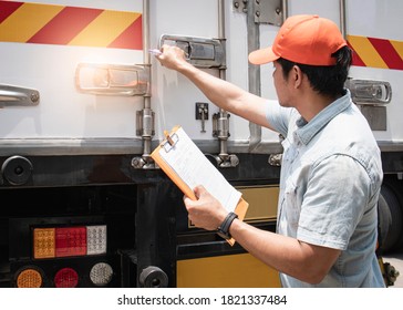 Asian a truck driver holding clipboard his checking safety cargo container steel door.  - Shutterstock ID 1821337484
