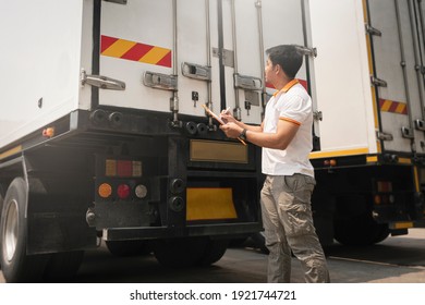 Asian A Truck Driver Holding Clipboard Checking Container Door Security. Truck Inspection Safety And Maintenance. Industry Cargo Freight Truck Transportation.