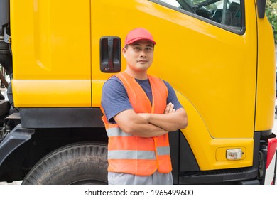 Asian Truck Driver In Safety Clothes Smile Confident. Happy Owner Transportation Business Stand Proudly Hug His Chest. Driving Trainer Skills In School, Teaching, Safety, Driving License.