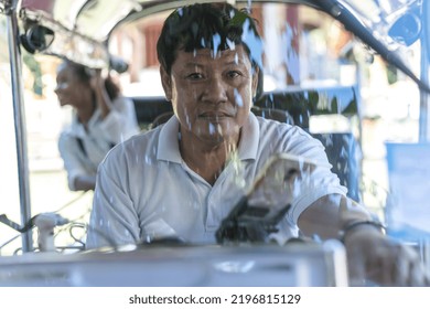 Asian tuk tuk driver man driving local tuktuk taxi with young tourist woman sitting in the back exploring and sightseeing Chiang mai,Thailand, tuk tuk taxi man taking visitor girl travel around city 