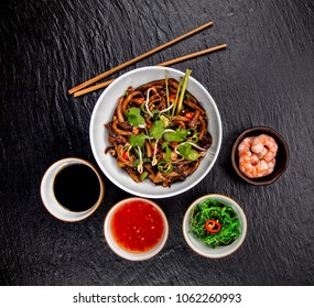 Asian Udon Noodles With Spicy Soy Sauce And Chicken Pieces Top View Served On