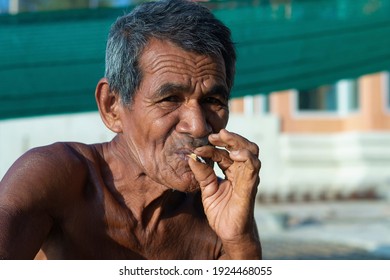 Asian Uncle Blessed From Smoking Leaves In The Morning At Bor Nok Beach, Prachuap Khiri Khan, Thailand,  March 11, 2563;