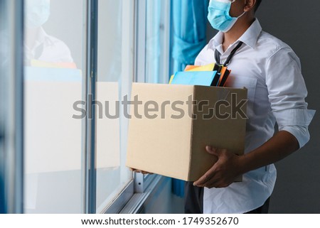 Asian unemployed person holds the document box by the window in hope, Unemployment in the Covid Virus Crisis 19. Business Failure Crisis was laid off from unemployment. 