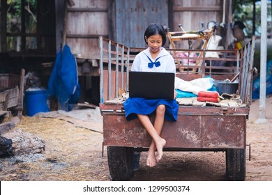 Asian Uniform Student Girl Using Computer Notebook In Countryside Of Thailand