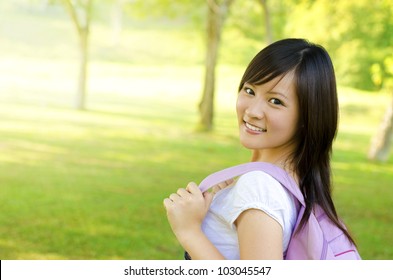 Asian University Student Walking On Outside Campus, Green Park