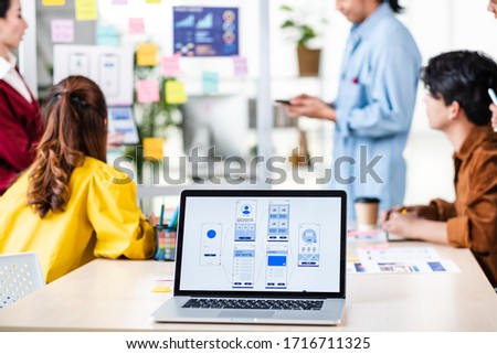 asian ux developer and ui designer presenting and testing mobile app interface design on whiteboard in meeting at modern office.Creative digital mobile app agency