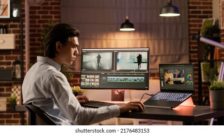 Asian videographer editing video montage with visual effects, using color gradient software to design movie footage for film production. Creative multimedia edit for professional content. - Shutterstock ID 2176483153