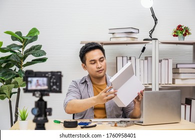 Asian Vlogger man recording Video about unboxing the hard ware and sharing knowledge to audience via camera for social media Live session, taking video and live, vlog and Influencer concept - Powered by Shutterstock