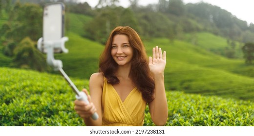 Asian Vlogger Traveler Woman Making Selfie On Mobile Phone Camera Share Via App Her Travel Vacation To Famous Nature Landmark Tea Plantations In Sri Lanka. Gen Z Talent Happy Girl Influencer Taking A Selfie