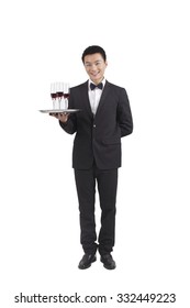 Asian Waiter Holding Tray Of Champagne