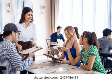 Asian waitress serving food to group of diverse customer in restaurant. Attractive female server service woman work by deliver meal and drink to consumer at their table in dining room with happiness. - Powered by Shutterstock