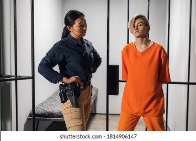 Asian Warden And A Female Prisoner In A High-security Prison Stand In Front Of An Open Cell