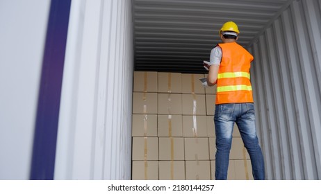 Asian Warehouse Staff Man Checking The Package Inside The Container, Asia Male Supervisor In A Large Distribution Center