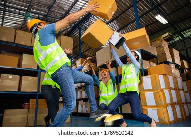 Asian warehouse workers occupational safety and health shocked someone slipped after step on the banana peel and a lot of carton overflowing. thunderstruck in store production.