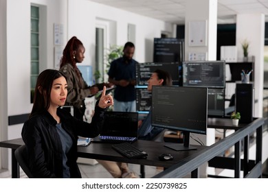 Asian web developer working with hologram and coding language in programming software company. Programmer analyzing holographic html code and augmented reality to develop new server interface. - Powered by Shutterstock