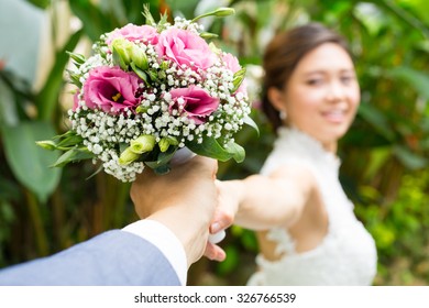 Asian wedding ,give flower to his girlfriend.