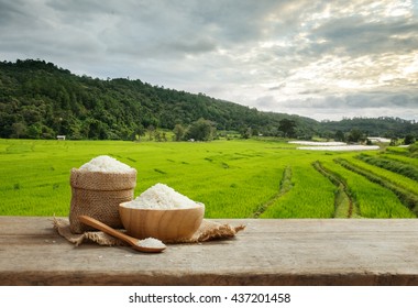 Asian White Rice Uncooked With The Rice Field Background