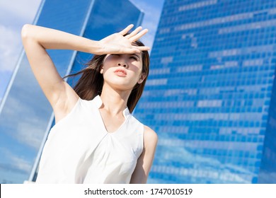 Asian woman afraid of suntan in the summer