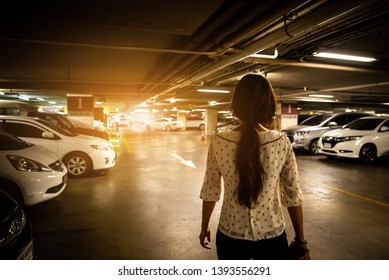 Asian Woman Alone On City Park Car Lot. Women Walking Alone In Underground Car Park Lot At Dark Night. Alone Pretty Asian Woman Walk To Car In Shopping Late At Night. Girl Working In City Night Alone 