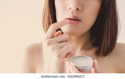 Asian Woman Apply Lips Balm . Lips Care On Her Natural Beauty Face