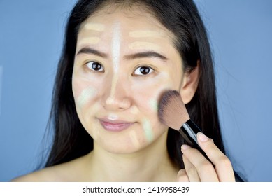 Asian Woman Applying Cosmetics Makeup And Using Color Correction Concealer, Face Skin Preparing Before Makeup Foundation, Learning Doing Self Makeup.