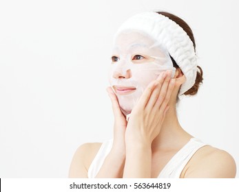 Asian Woman Applying A Face Pack  