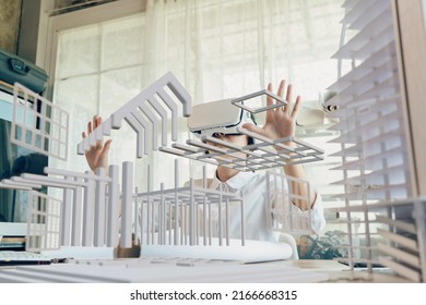 Asian woman Architect or Engineer wearing VR headset for working design 3D architectural precast concrete building model with BIM technology and virtual reality technology. Concept futuristic design.  - Powered by Shutterstock