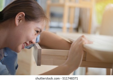 Asian Woman Assembling New DIY Furniture At Home