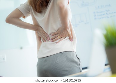 Asian Woman With Back Pain In Office