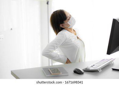 Asian Woman With Back Pain In Office