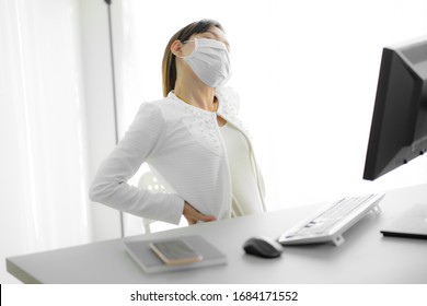 Asian Woman With Back Pain In Office