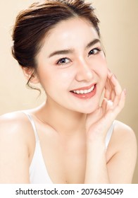 Asian woman with a beautiful face and fresh, smooth skin. Cute female model with natural makeup and sparkling eyes is posing on white isolated background. - Shutterstock ID 2076345049
