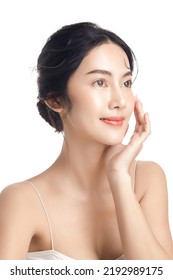 Asian Woman With A Beautiful Face And Perfect Clean Fresh Skin. Cute Female Model With Natural Makeup And Sparkling Eyes On White Isolated Background. Facial Treatment, Cosmetology, Beauty Concept.