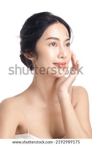 Asian woman with a beautiful face and Perfect clean fresh skin. Cute female model with natural makeup and sparkling eyes on white isolated background. Facial treatment, Cosmetology, beauty Concept.
