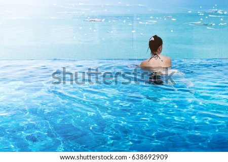 asian Woman in bikini relaxing at the pool summer comcept