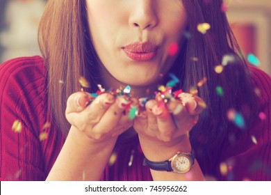 Asian Woman Blowing Glitter, Celebration Concept.