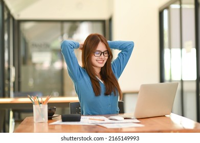 Asian Woman In Blue Shirt Stretching Her Arms To Relax. During Work In The Office, Office Syndrome, Business Idea, Office Equipment.