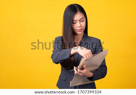 Asian woman In a blue suit With his various postures in the yellow background