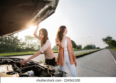 Asian Woman Broken Car On The Road For The Phone. Tell A Car Mechanic