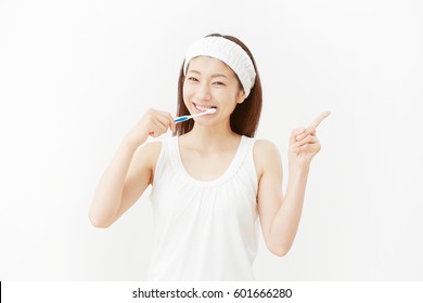 Asian Woman Brushing The Teeth