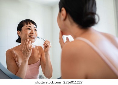 Asian woman brushing teeth in the bathroom - Powered by Shutterstock