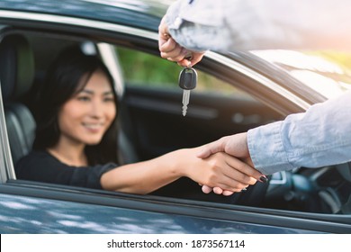 Asian Woman Buying Or Renting Rental New Car Owner Car Key Hand Shake From Sales Seller, Taking And Passing Driving License Examination Test Happy Cheerful Smiling Excited Salesman Sold Car Dealership