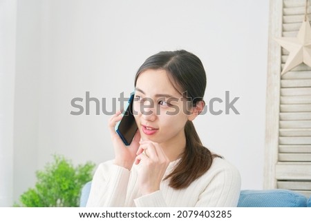 Asian woman calling at home