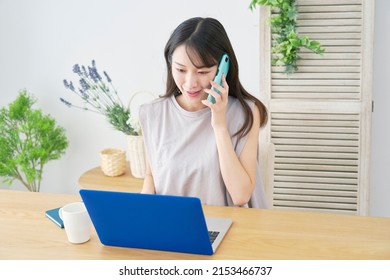 Asian woman calling with the smartphone at home