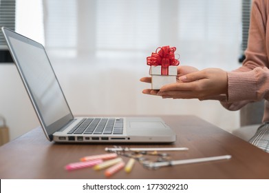 Asian Woman Celebrating Birthday Through Video Call Online Holding Giftbox And Cup Cake On Hand While Isolated Stay At Home