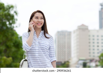 Asian Woman Cell Phone Call Smile Looking Side Talking City Street