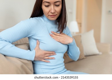 Asian Woman checking lumps on her breast for signs of cancer. woman is suffering from pain in the breast. BSE or Breast Self-Exam. Guidelines to check for breast cancer. - Shutterstock ID 2143539155
