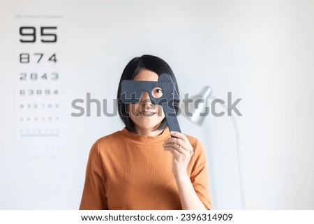 Asian woman checking up vision closing eyes test at hospital