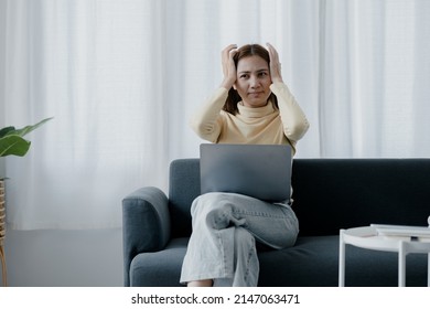 Asian Woman Checking Work From Laptop And Stressed Due To Work Problems On Holidays, She Is Taking The Day Off To Work Causing Her Stress And Does Not Take The Day Off To Relax. Hard Work Concept.